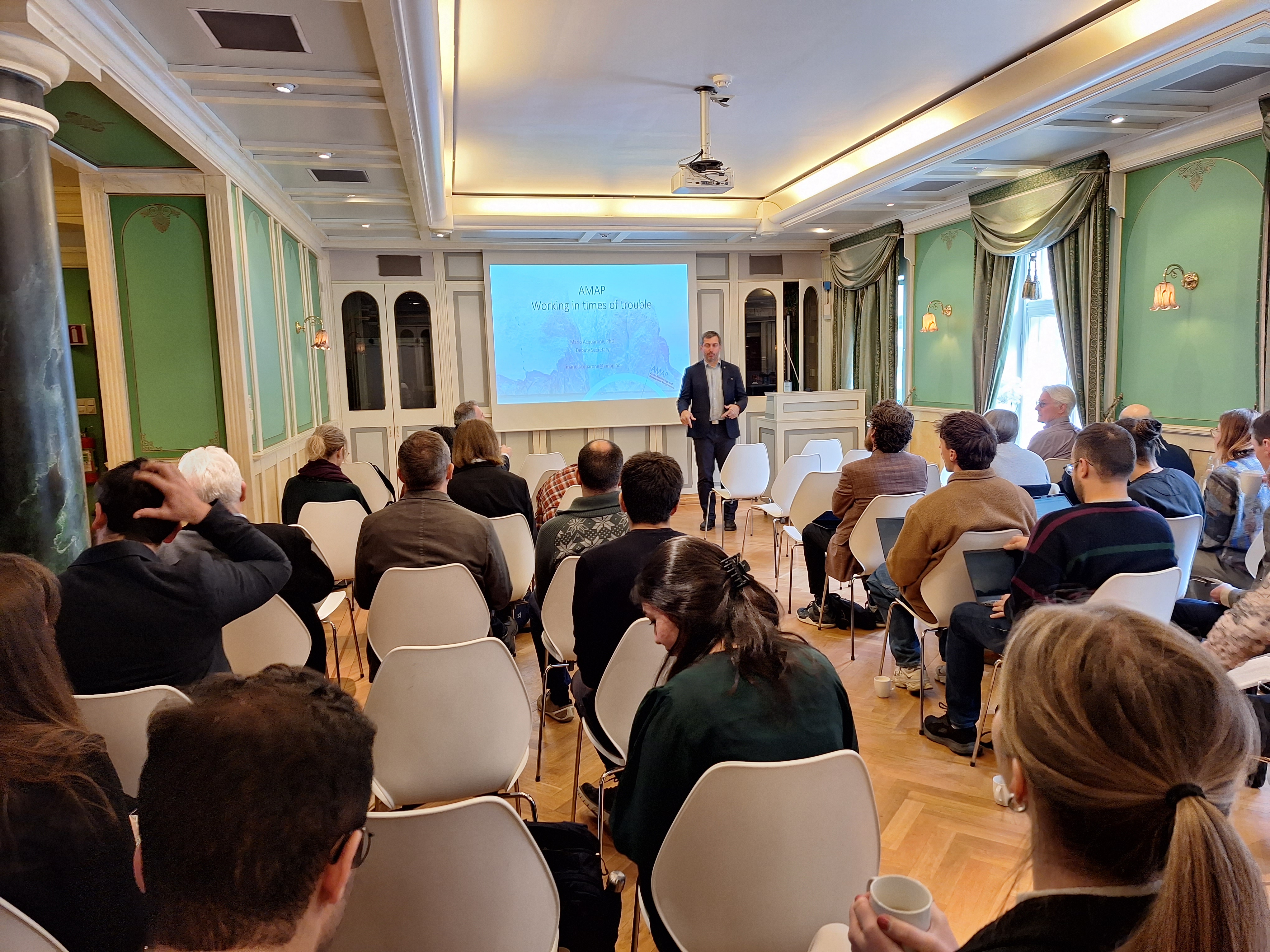 The audience is listening to a presentation at the FALG workshop