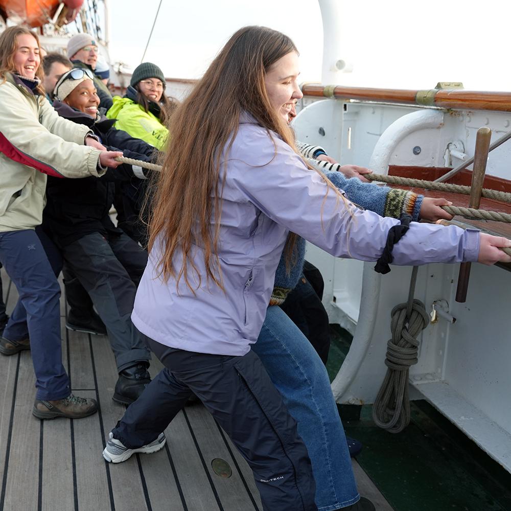 Persons pulling a rope